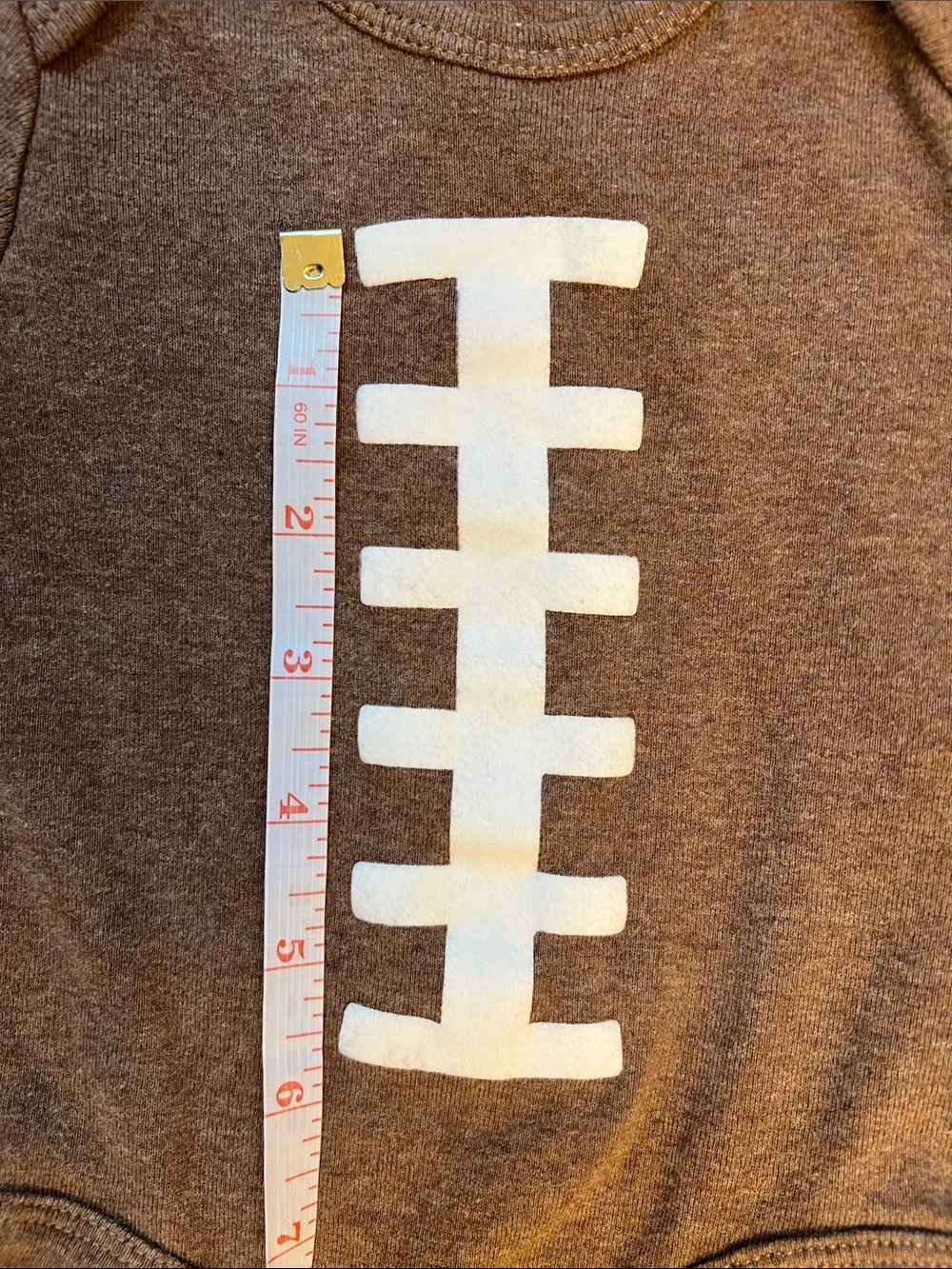 Carter’s | Brown Football-Stitch Long-Sleeve Baby One-Piece Size 3 Months